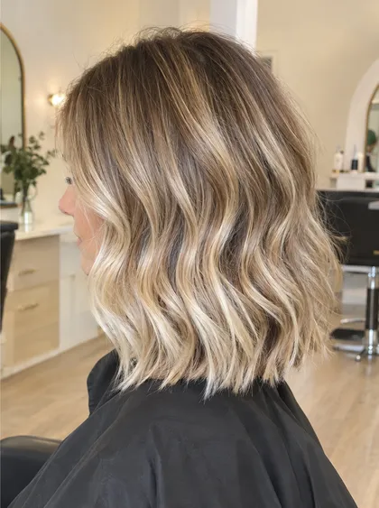 After: bright dimensional blonde balayage lob