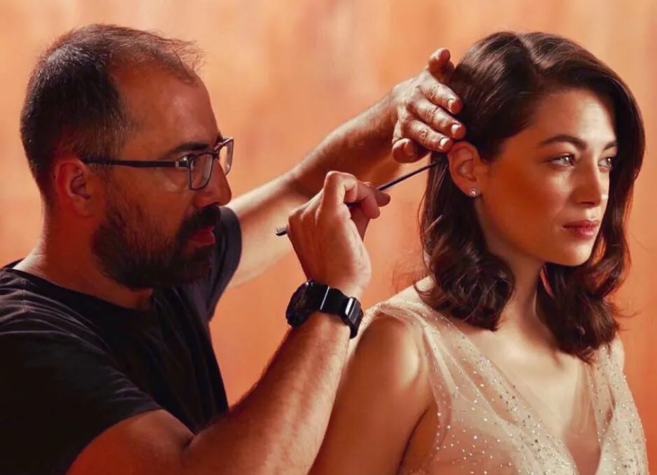 A Team Hair Pro stylist finishing a soft, glossy wave